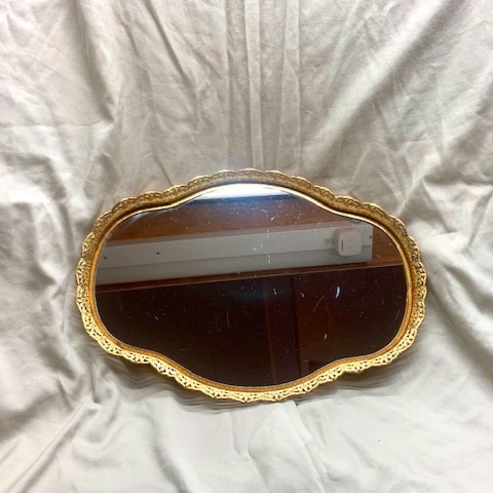 Vintage oval mirror with gold metal frame